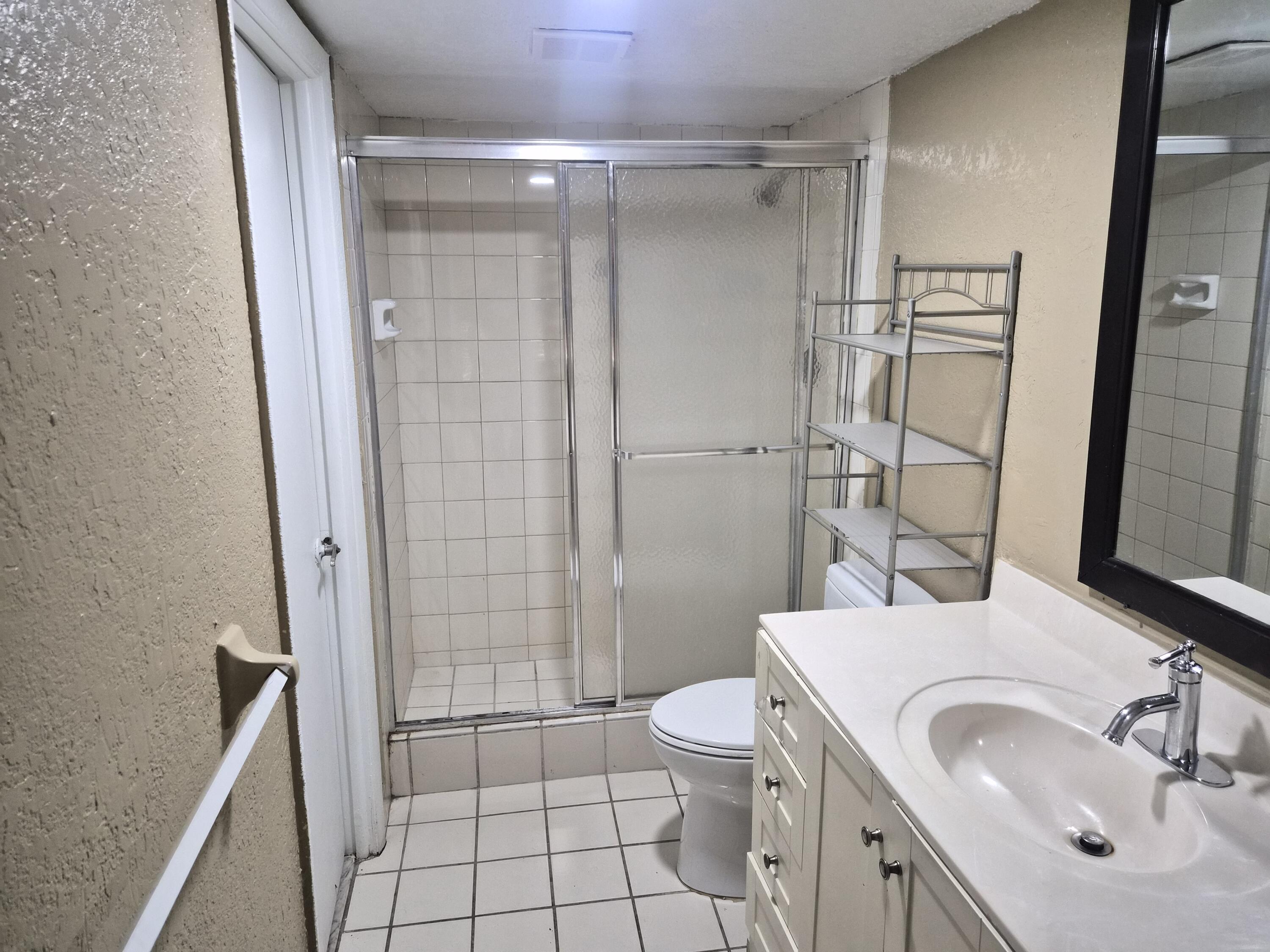 4166 Inverrary Drive, Unit 403 Lauderhill, FL 33319 - Photo 30 of 32 a bathroom with a sink toilet and shower