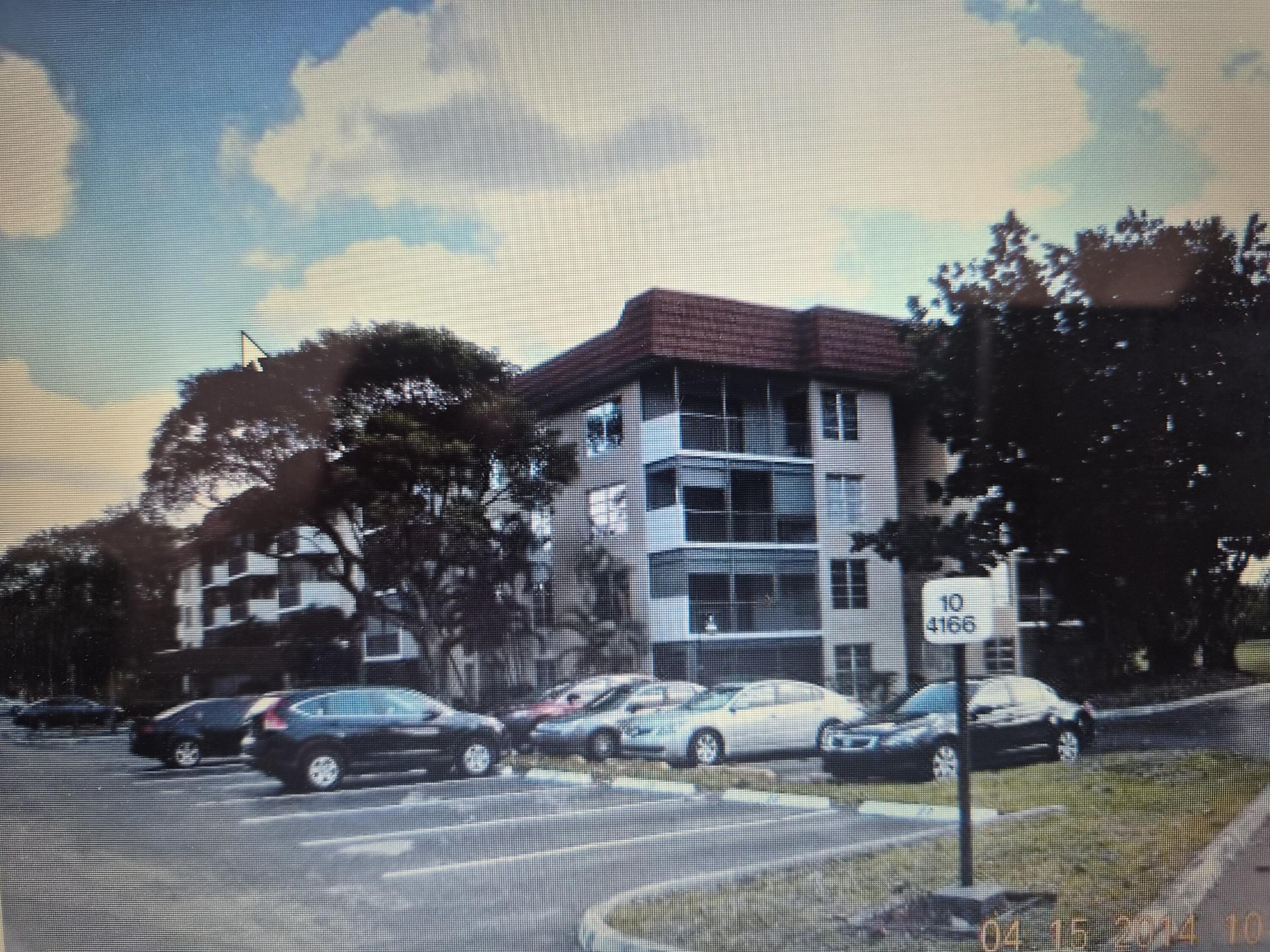 4166 Inverrary Drive, Unit 403 Lauderhill, FL 33319 - Photo 7 of 32 a cars parked in front of a house