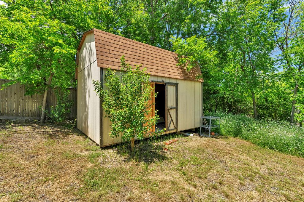5108 Crown Road Fort Worth, TX 76114 - Photo 16 of 22 Detached storage shed with barn-style roof and sliding door entry