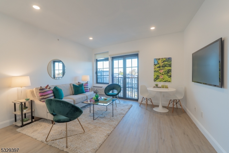 1026 Stuyvesant Avenue, Unit 207 Union, NJ 07083 - Photo 2 of 11 a living room with furniture and a flat screen tv