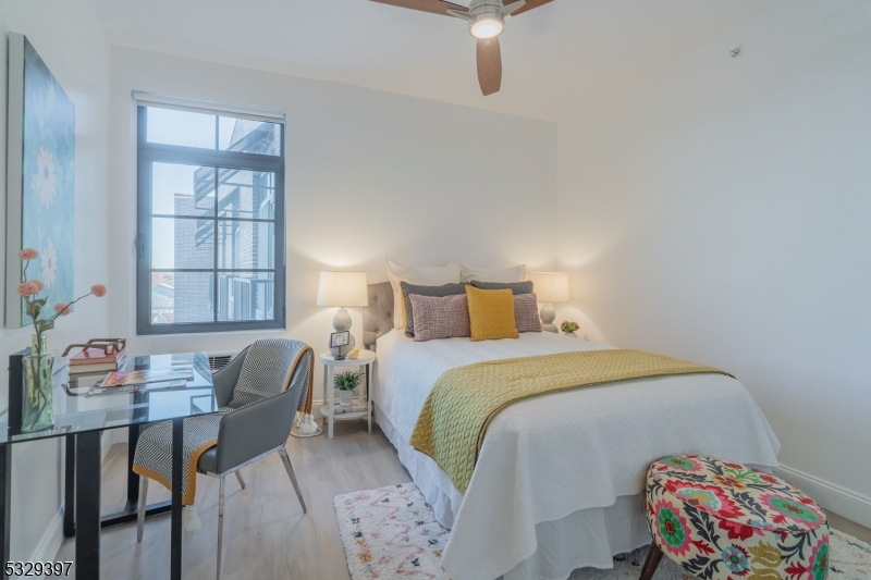 1026 Stuyvesant Avenue, Unit 207 Union, NJ 07083 - Photo 8 of 11 a bedroom with a bed and a table in it