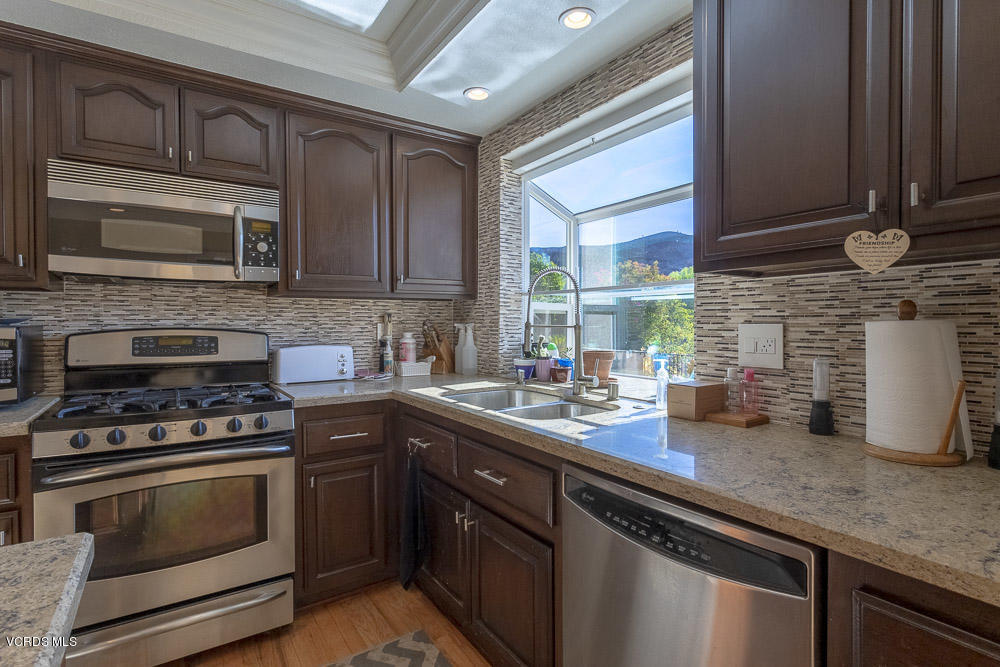 1168 Rambling Road Simi Valley, CA 93065 - Photo 11 of 45 a kitchen with a sink stove and microwave