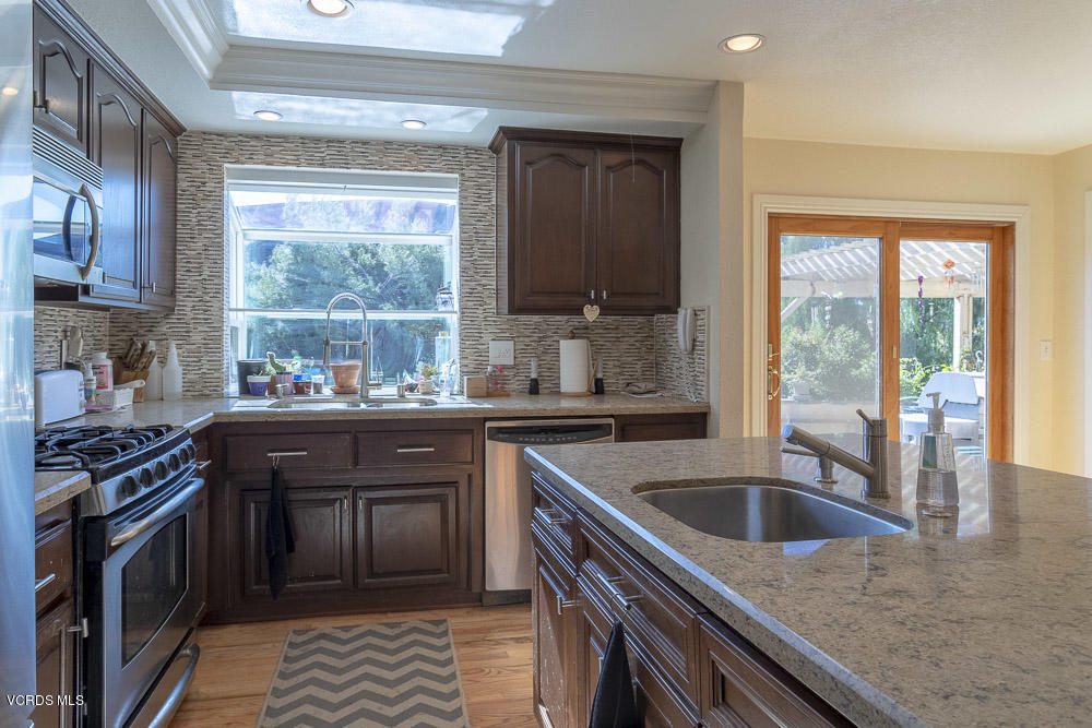 1168 Rambling Road Simi Valley, CA 93065 - Photo 12 of 45 a kitchen with granite countertop a stove and a sink