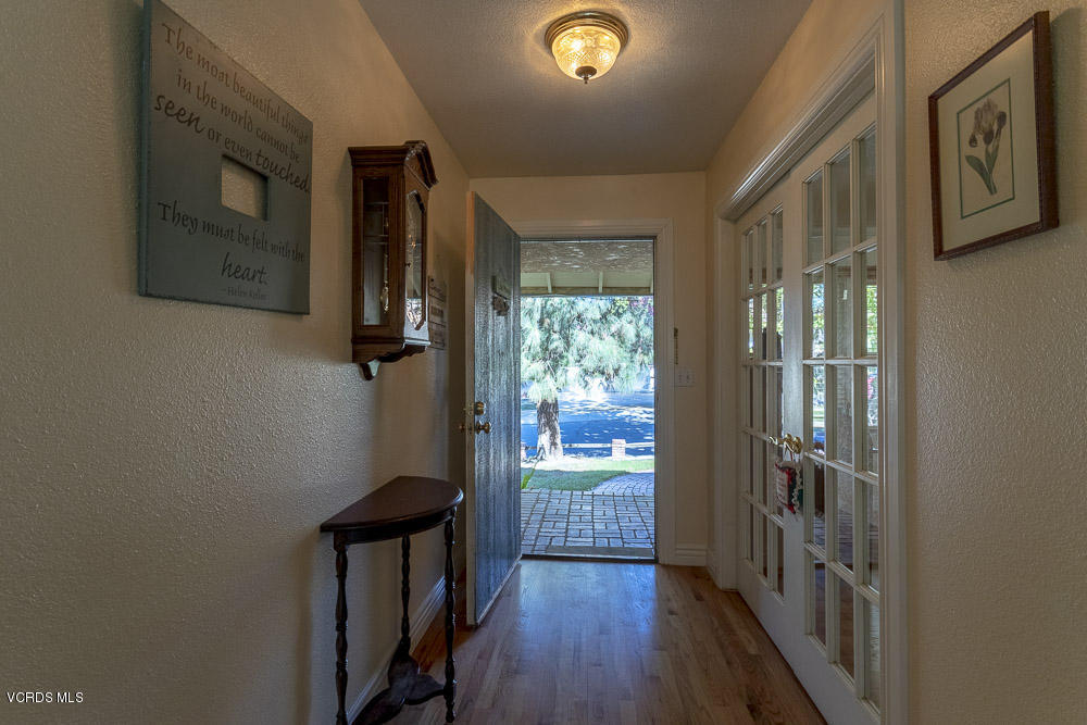 1168 Rambling Road Simi Valley, CA 93065 - Photo 4 of 45 a view of a hallway with wooden floor and entryway