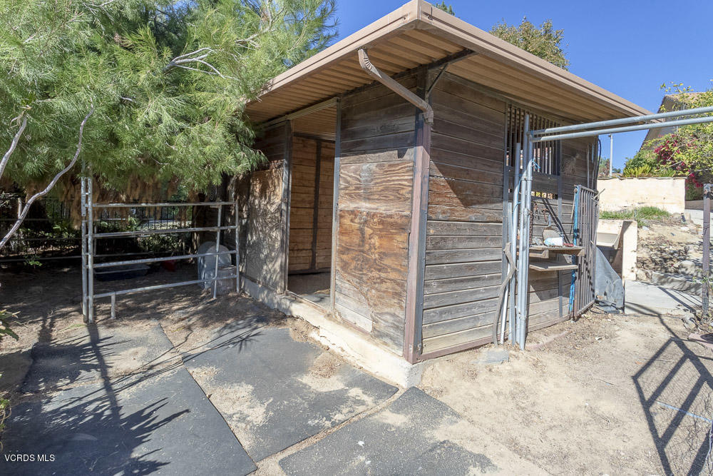 1168 Rambling Road Simi Valley, CA 93065 - Photo 33 of 45 a view of a wooden house with a chair and table