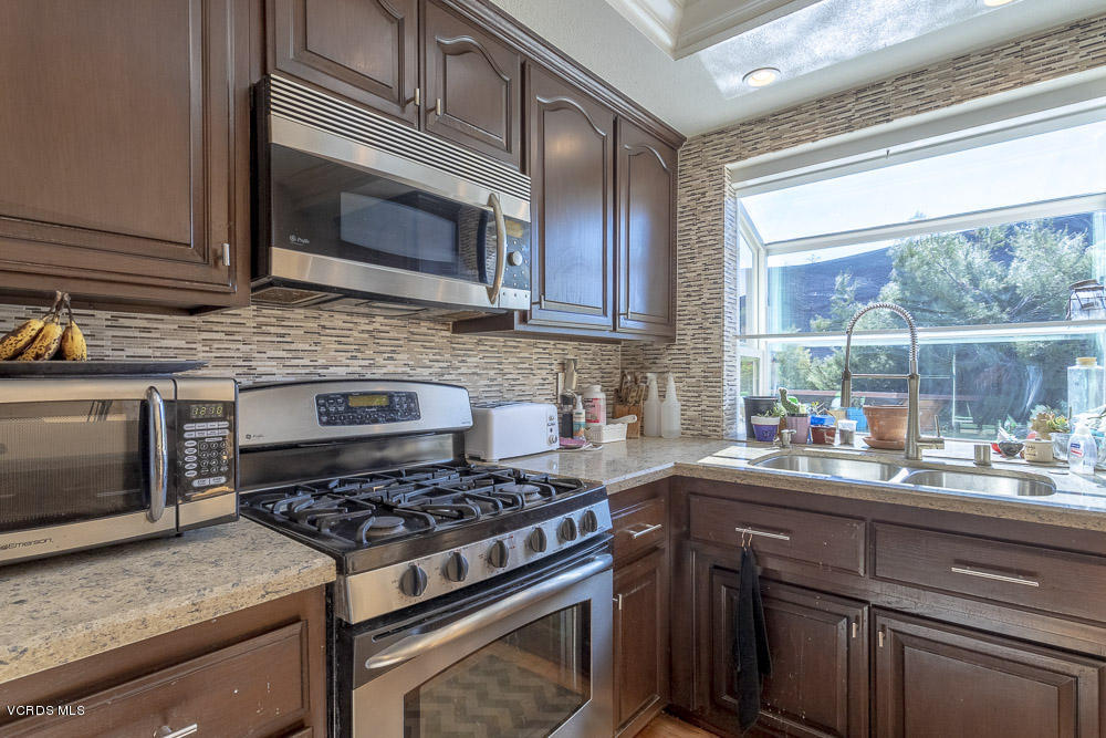 1168 Rambling Road Simi Valley, CA 93065 - Photo 10 of 45 a kitchen with a stove and a microwave