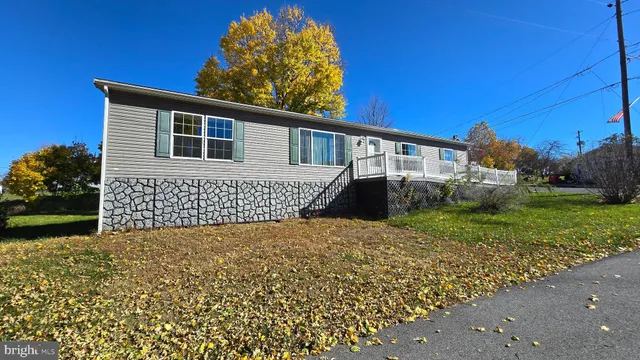 a backyard of a house with lots of green space and outdoor seating
