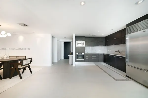 a kitchen with stainless steel appliances kitchen island granite countertop a sink and cabinets