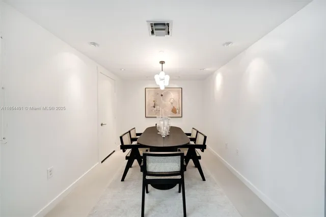 a view of a room with a table and chairs