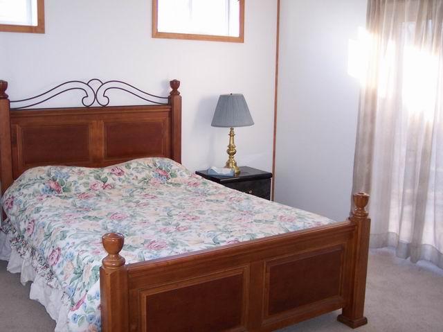 205 Cedar Road Effort, PA 18330 - Photo 5 of 7 a bedroom with a bed and a table