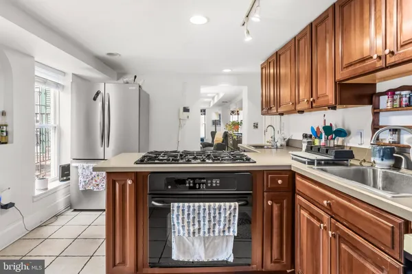 a kitchen with stainless steel appliances granite countertop a stove top oven a sink dishwasher and cabinets