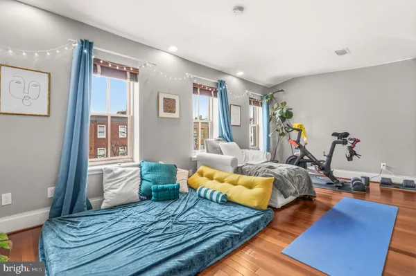 a bedroom with furniture and wooden floor
