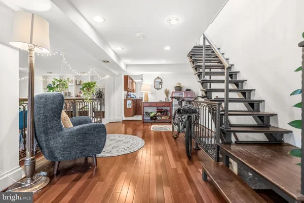 a living room with furniture and wooden floor