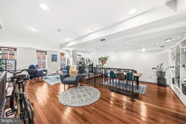 a living room with furniture and a wooden floor