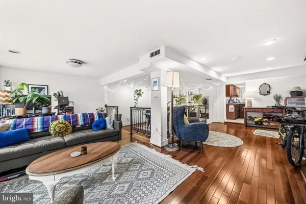 a living room with furniture and wooden floor