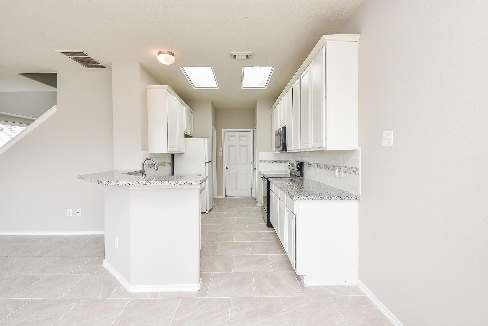 5619 Stonecloud Lane Katy, TX 77494 - Photo 12 of 31 a utility room with cabinets washer and dryer
