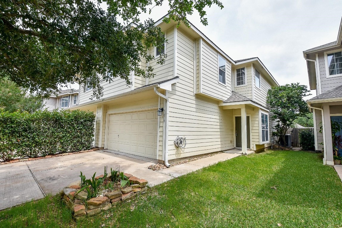5619 Stonecloud Lane Katy, TX 77494 - Photo 2 of 31 a view of a house with a yard and flower plants