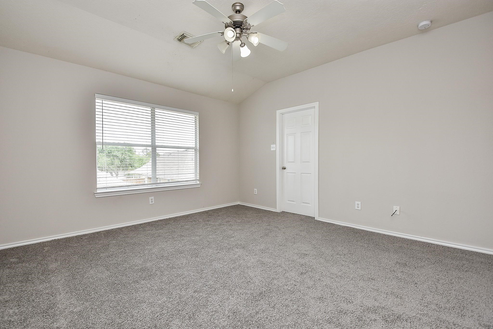 5619 Stonecloud Lane Katy, TX 77494 - Photo 23 of 31 an empty room with a window and ceiling fan
