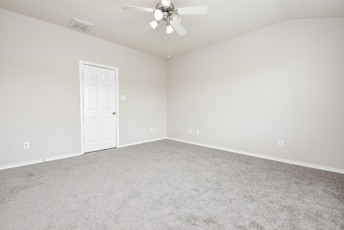 5619 Stonecloud Lane Katy, TX 77494 - Photo 25 of 31 an empty room with a chandelier fan and windows