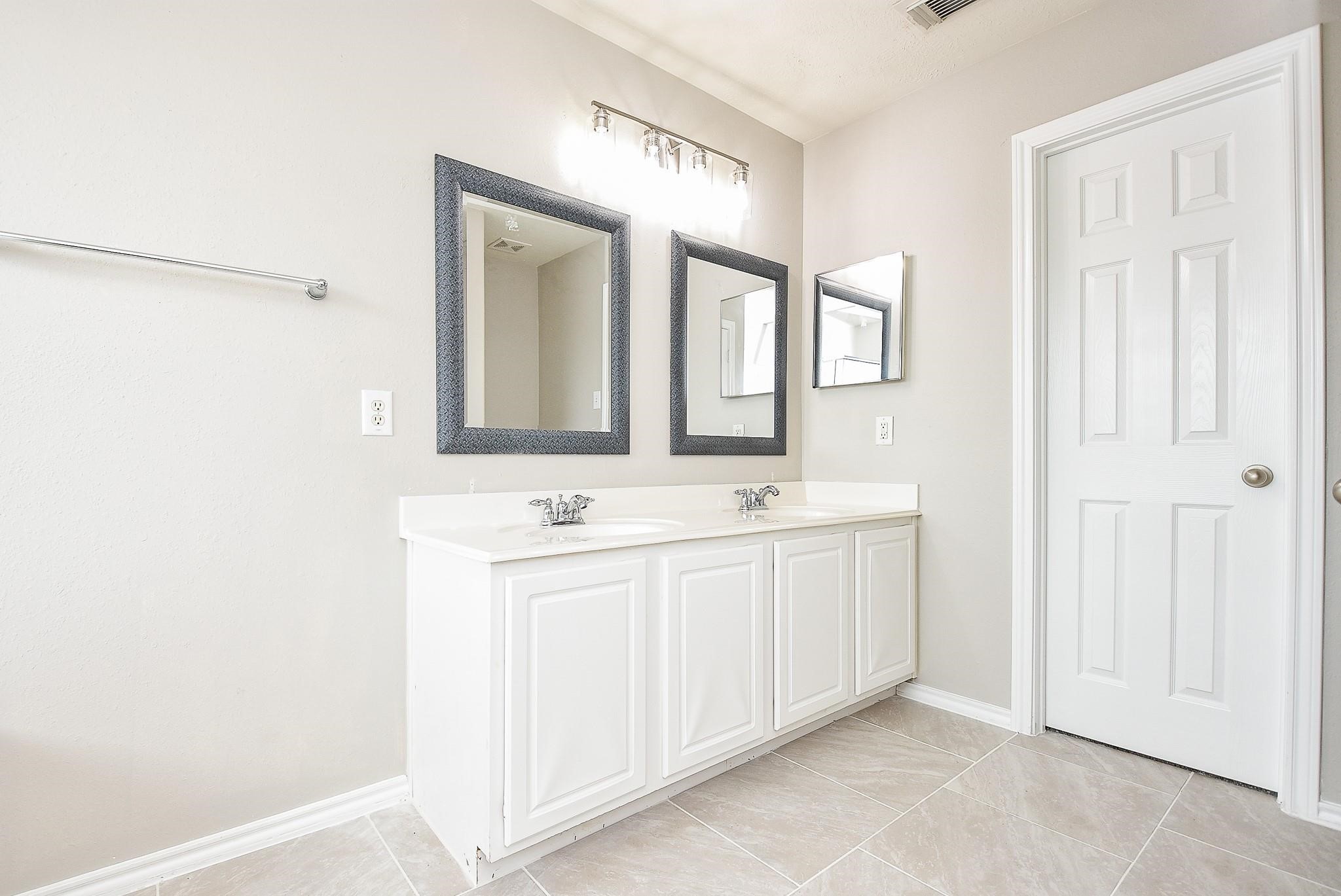 5619 Stonecloud Lane Katy, TX 77494 - Photo 26 of 31 a bathroom with a double vanity sink and mirror