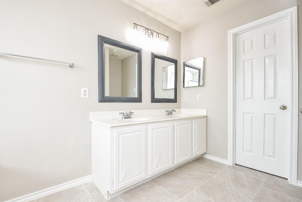 5619 Stonecloud Lane Katy, TX 77494 - Photo 26 of 31 a bathroom with a double vanity sink and mirror