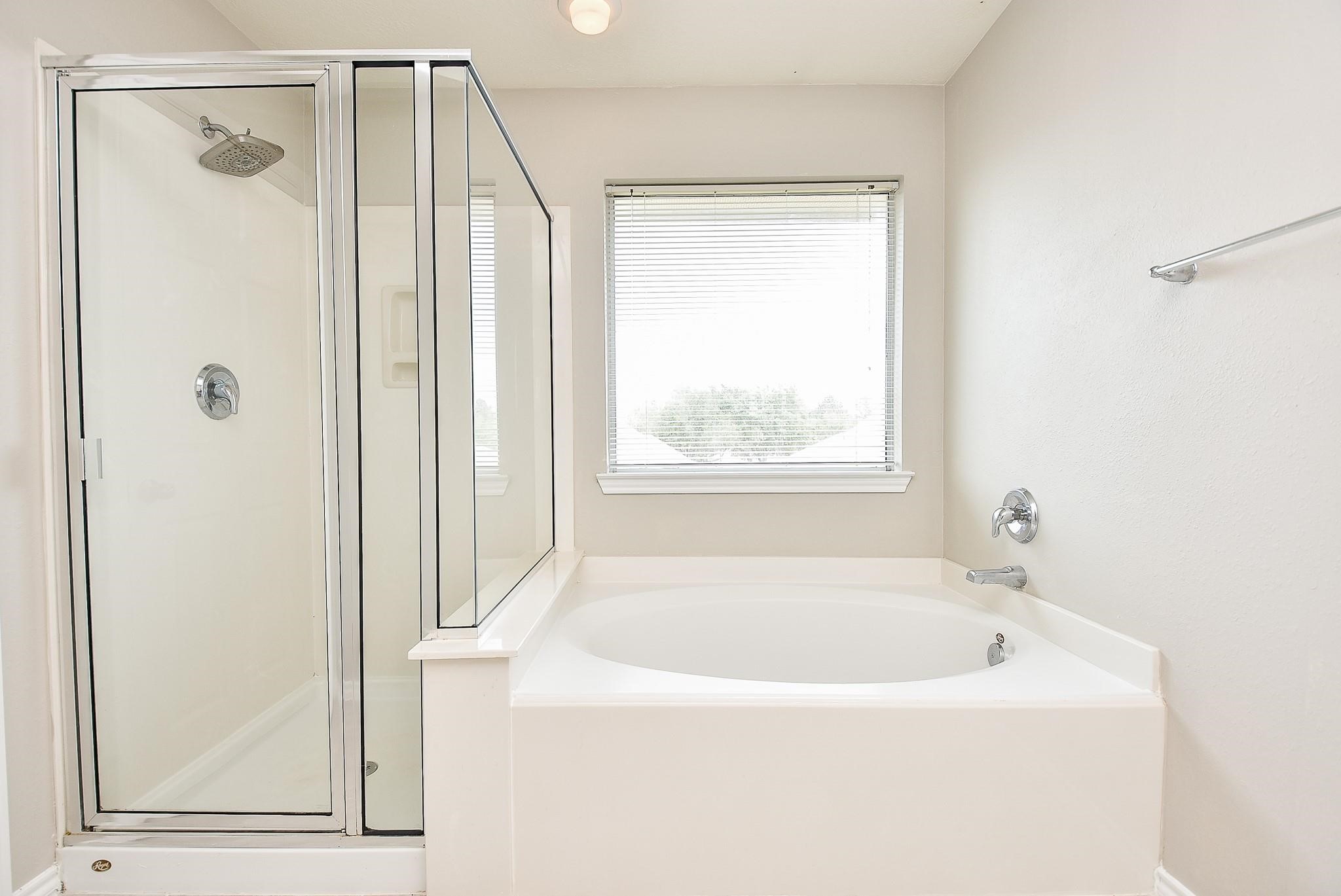5619 Stonecloud Lane Katy, TX 77494 - Photo 28 of 31 a white bath tub sitting next to a shower