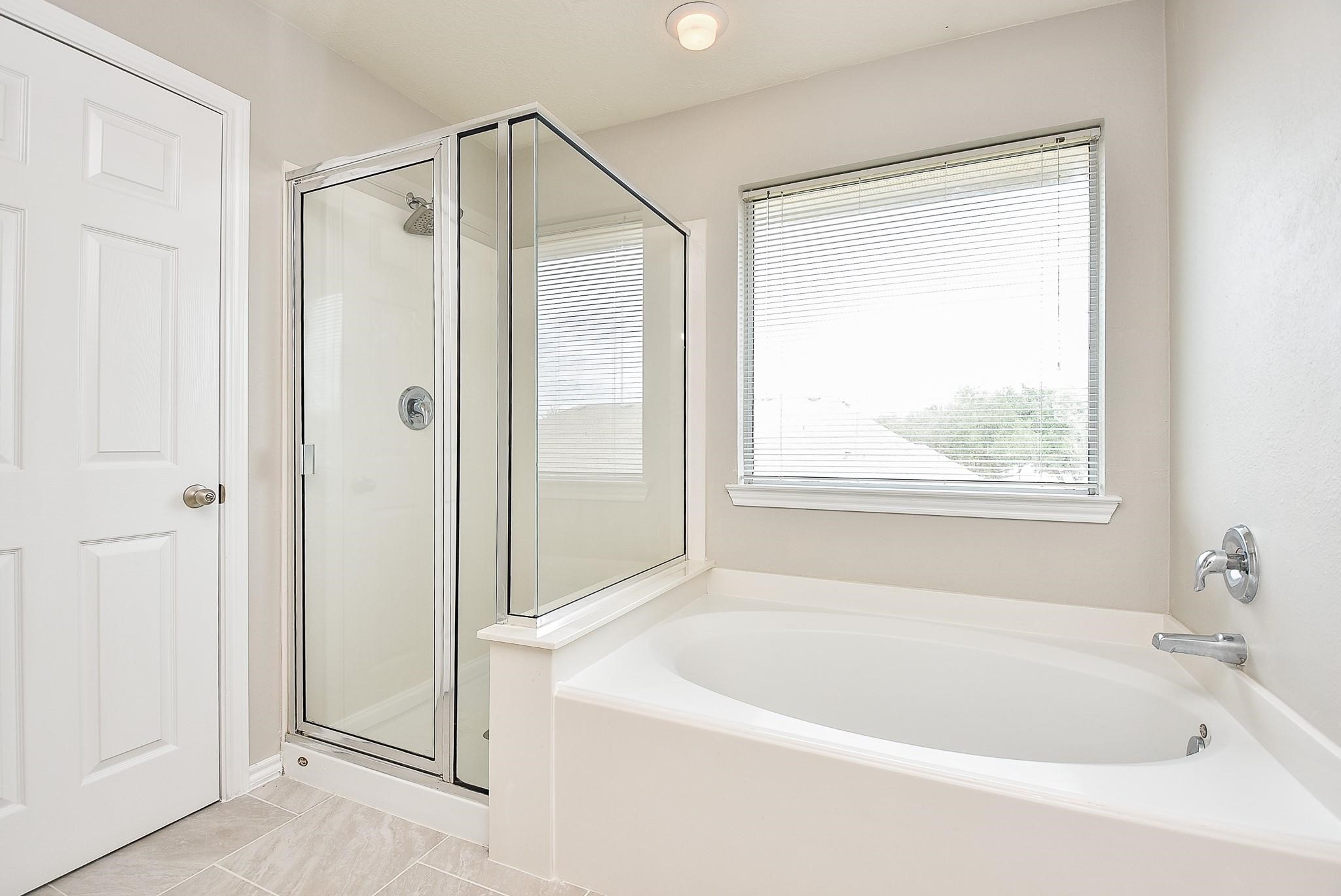 5619 Stonecloud Lane Katy, TX 77494 - Photo 29 of 31 a white bath tub sitting next to a shower