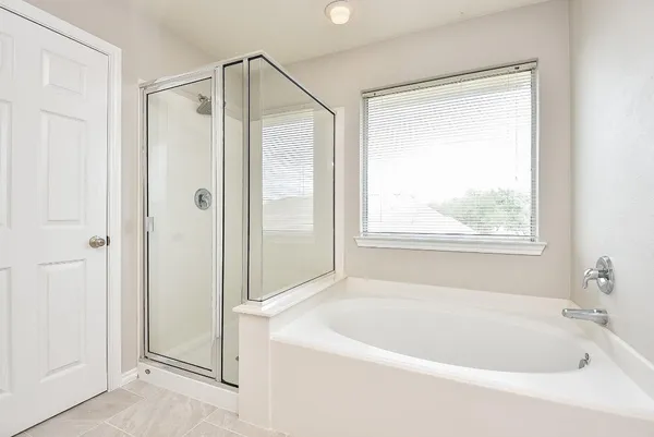 a white bath tub sitting next to a shower
