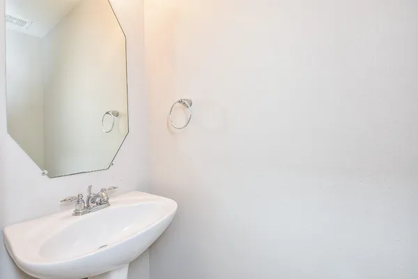 a bathroom with a sink and mirror