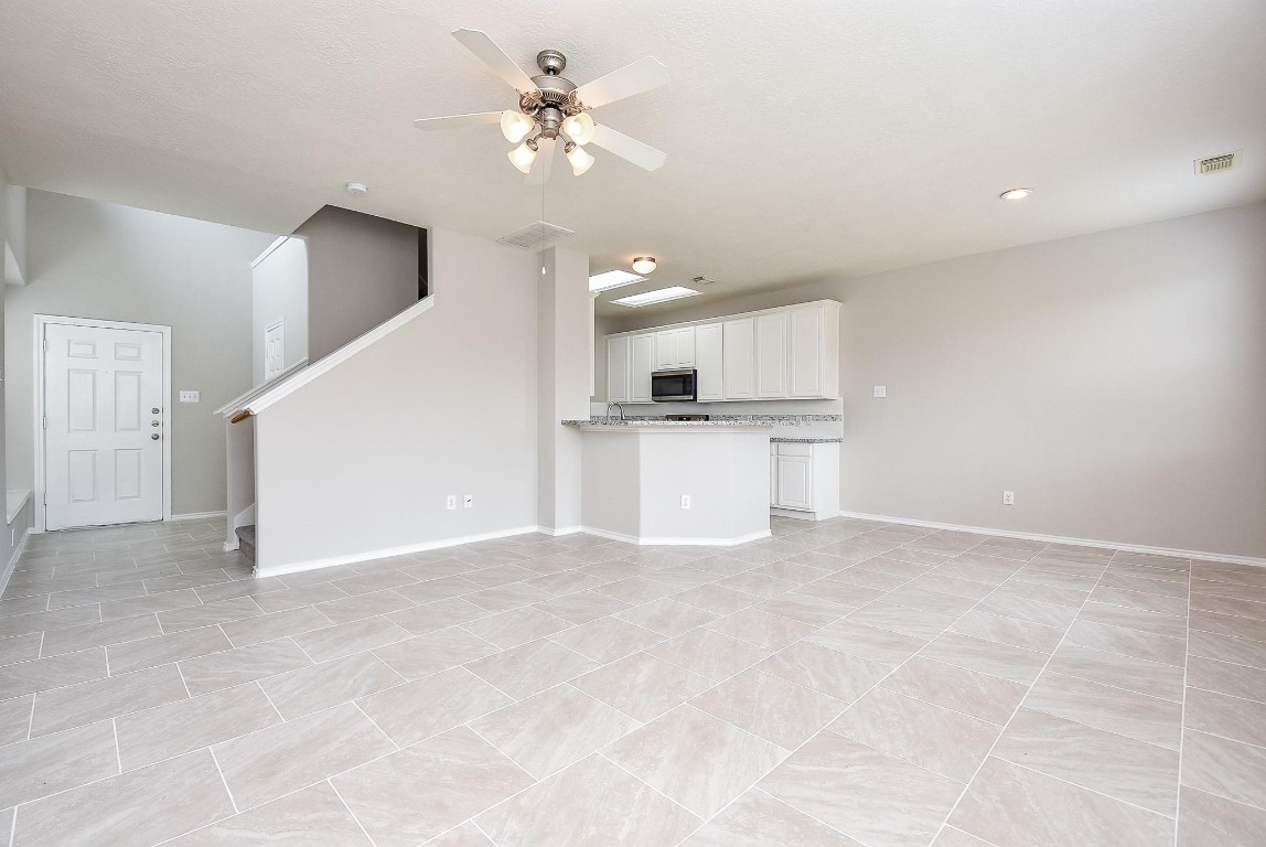 5619 Stonecloud Lane Katy, TX 77494 - Photo 10 of 31 a view of a kitchen with a sink and a kitchen counter top