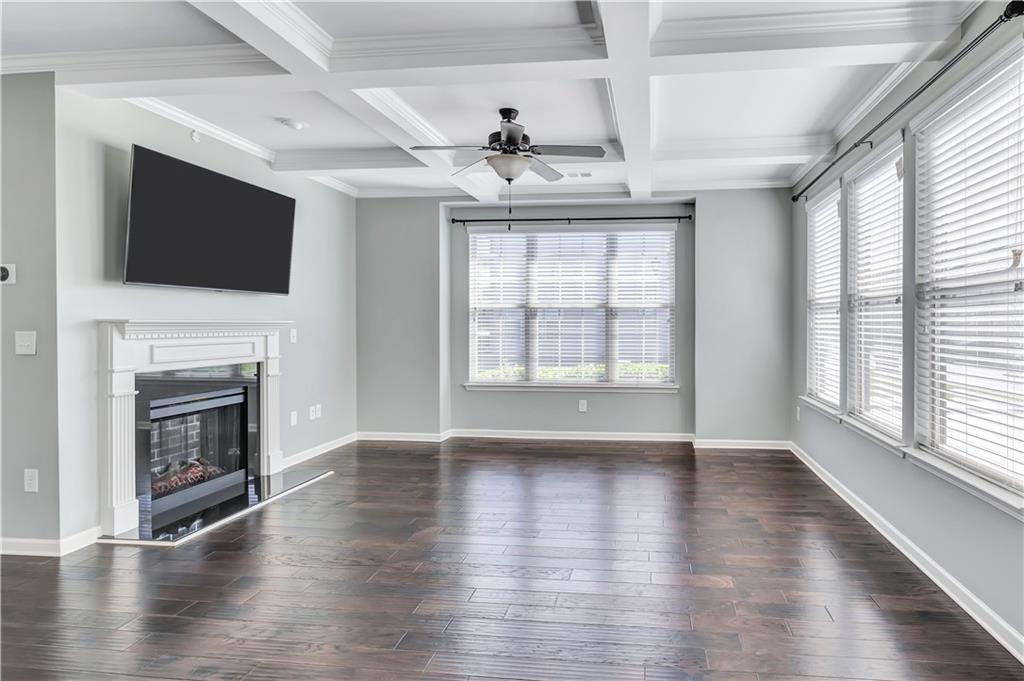 330 Avalon Square Fairburn, GA 30213 - Photo 2 of 52 a view of an empty room with wooden floor fireplace and a window