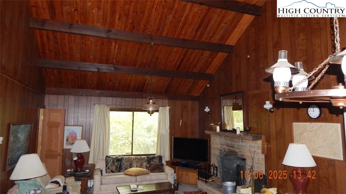 5359 Castle Ford Road Boone, NC 28607 - Photo 4 of 11 a living room with furniture a flat screen tv and a fireplace