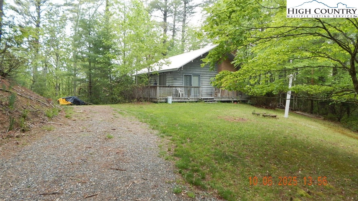 5359 Castle Ford Road Boone, NC 28607 - Photo 9 of 11 a backyard of a house with plants and large trees