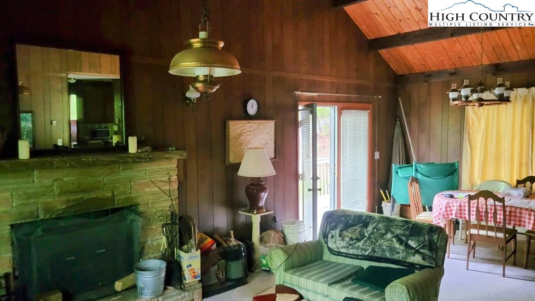 5359 Castle Ford Road Boone, NC 28607 - Photo 10 of 11 a living room filled with furniture and a chandelier