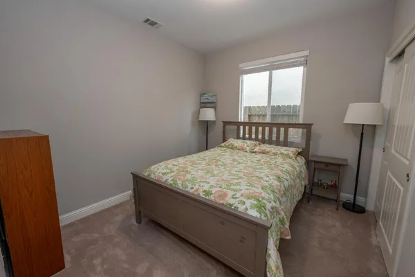 a bed sitting in a bedroom next to a window
