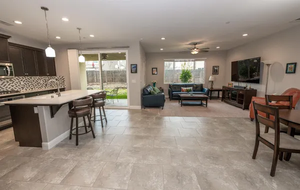 a living room with furniture a flat screen tv and a large window