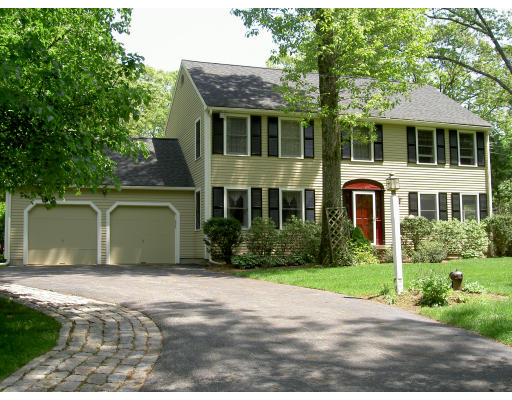 a front view of a house with a garden and plants