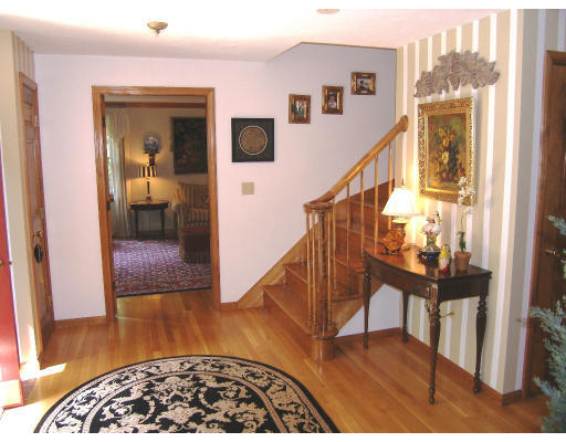 18 Parmenter Road Framingham, MA 01701 - Photo 7 of 18 a view of a hallway with wooden floor and stairs
