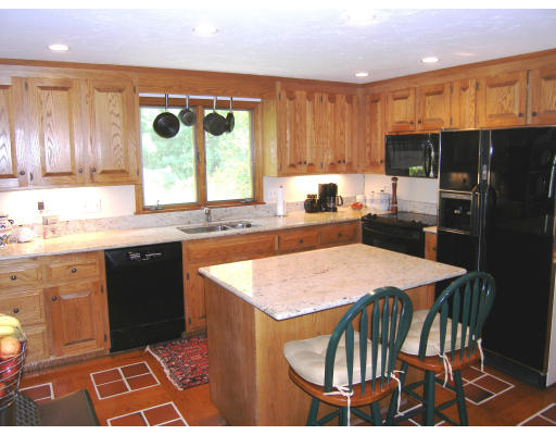 18 Parmenter Road Framingham, MA 01701 - Photo 10 of 18 a kitchen with stainless steel appliances granite countertop a stove a sink dishwasher and a refrigerator with wooden cabinets