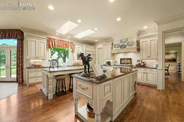 a kitchen with stainless steel appliances granite countertop a sink and cabinets