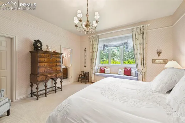 a bedroom with a bed and a flat tv screen on dresser