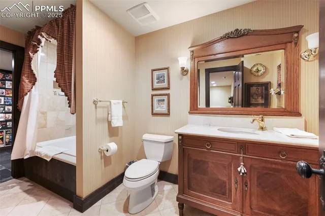 a dining area with furniture a chandelier and a flat screen tv