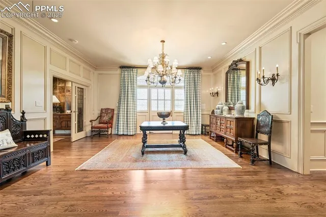 a living room with furniture a table and a chandelier