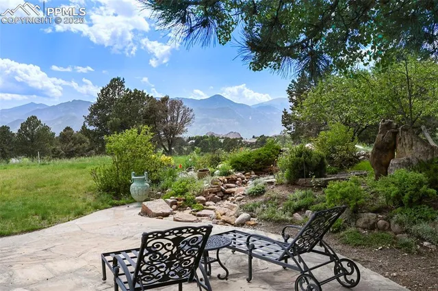 a view of a patio with table and chairs under an umbrella