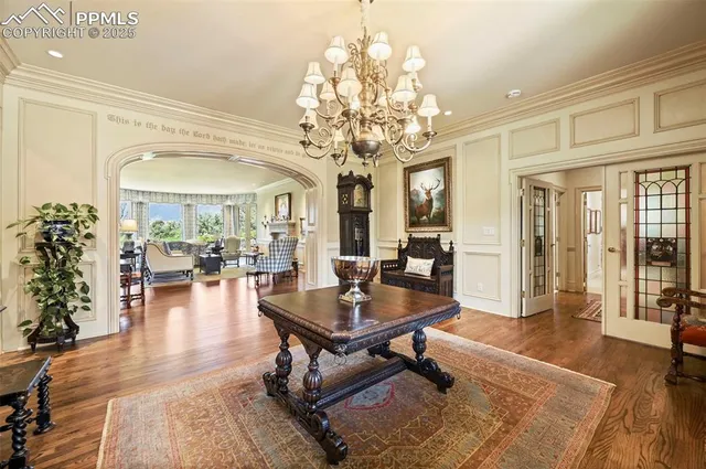 a living room with furniture and a chandelier
