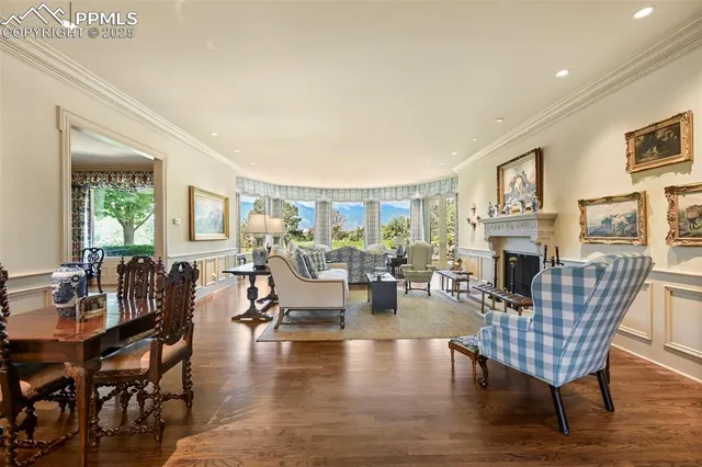 a living room with fireplace furniture and a wooden floor