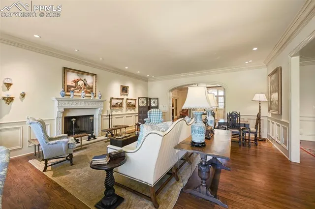 a living room with furniture a fireplace and a table