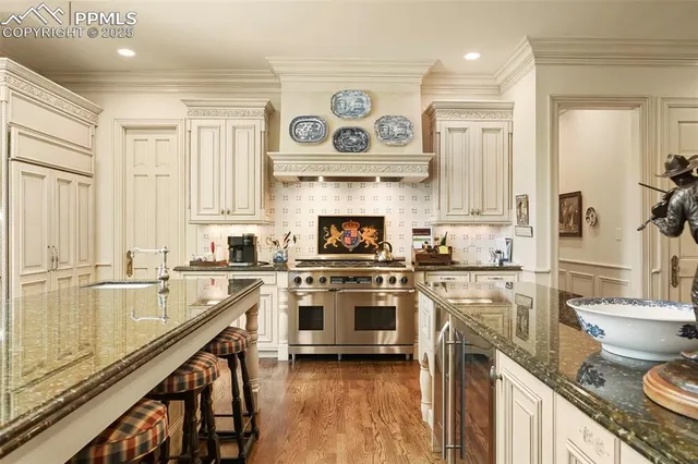 a kitchen with a stove a sink and a refrigerator