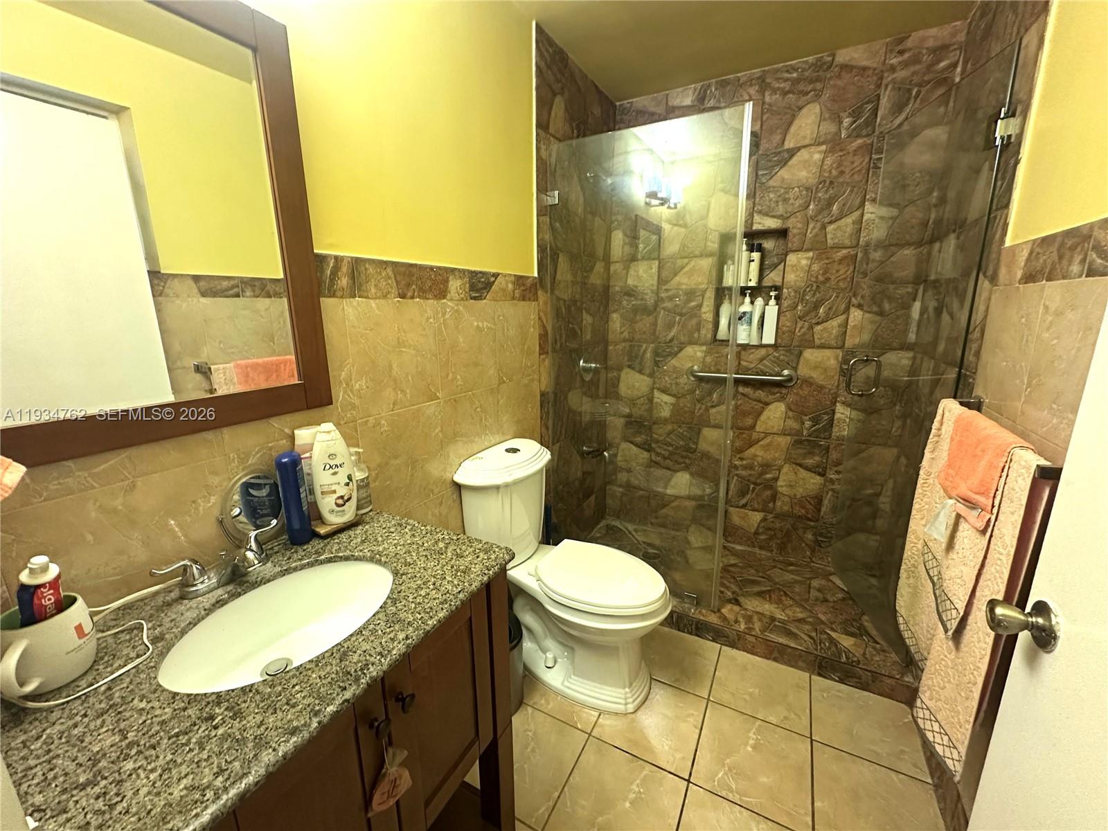 4361 Southwest 3rd Street Miami, FL 33134 - Photo 15 of 24 a bathroom with a granite countertop sink toilet and shower