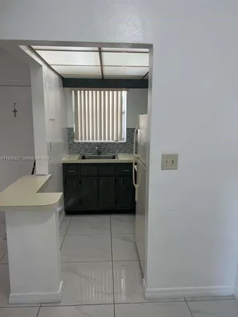 a bathroom with a bathtub sink and mirror